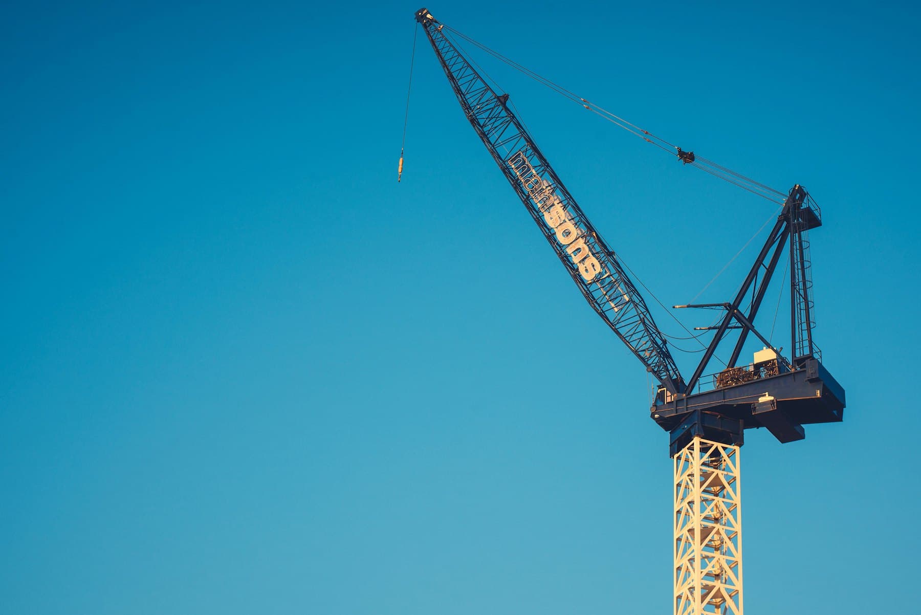 Heavy-lift crane against a clear blue sky
