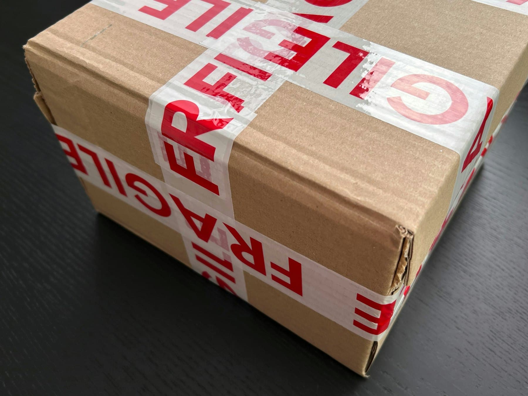 Carton sealed with fragile tape