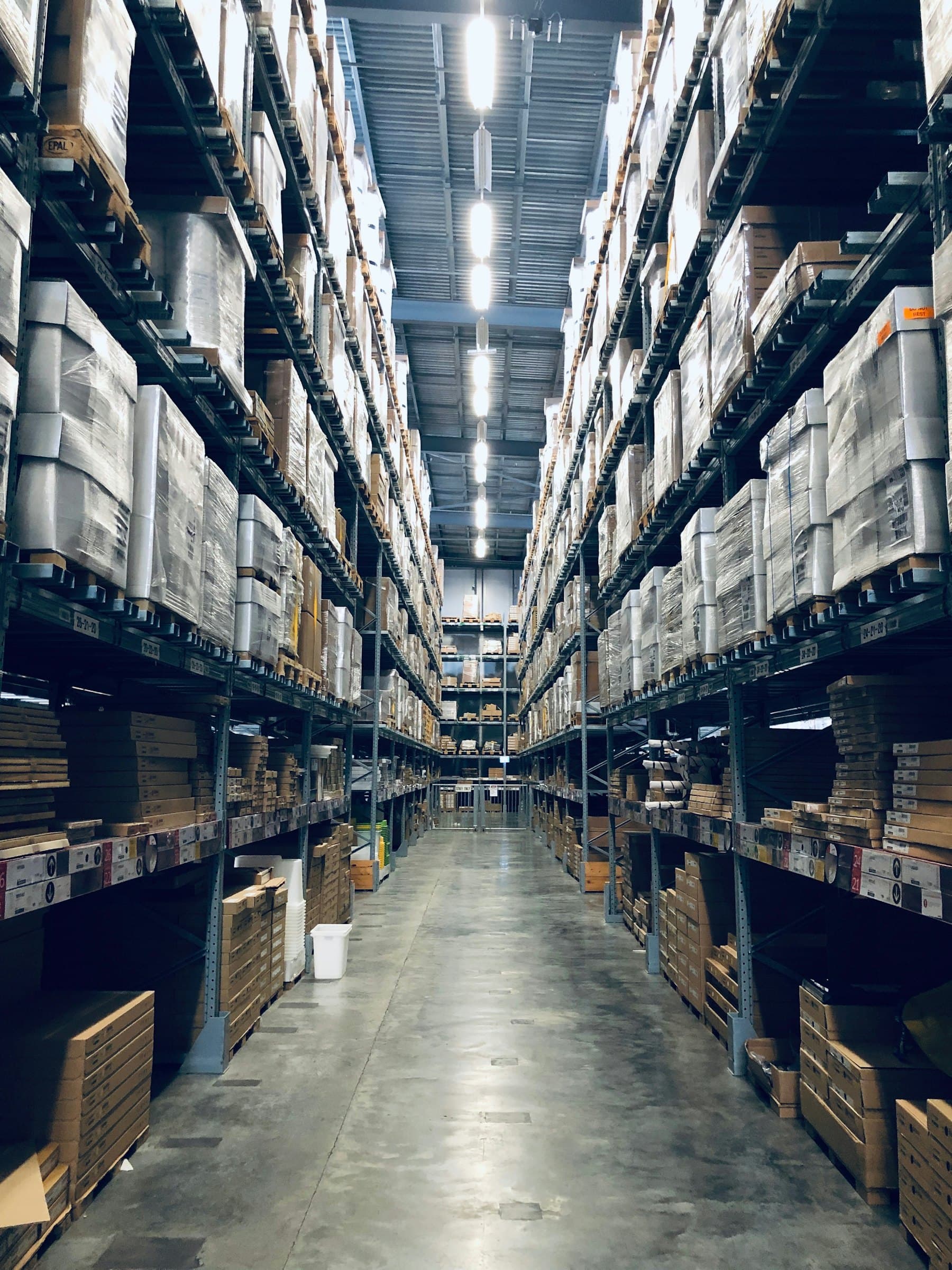Tall racking filled with cartons in a warehouse aisle